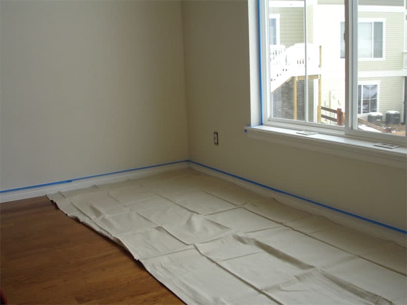 Drop cloths and blue painter’s tape during job preparation